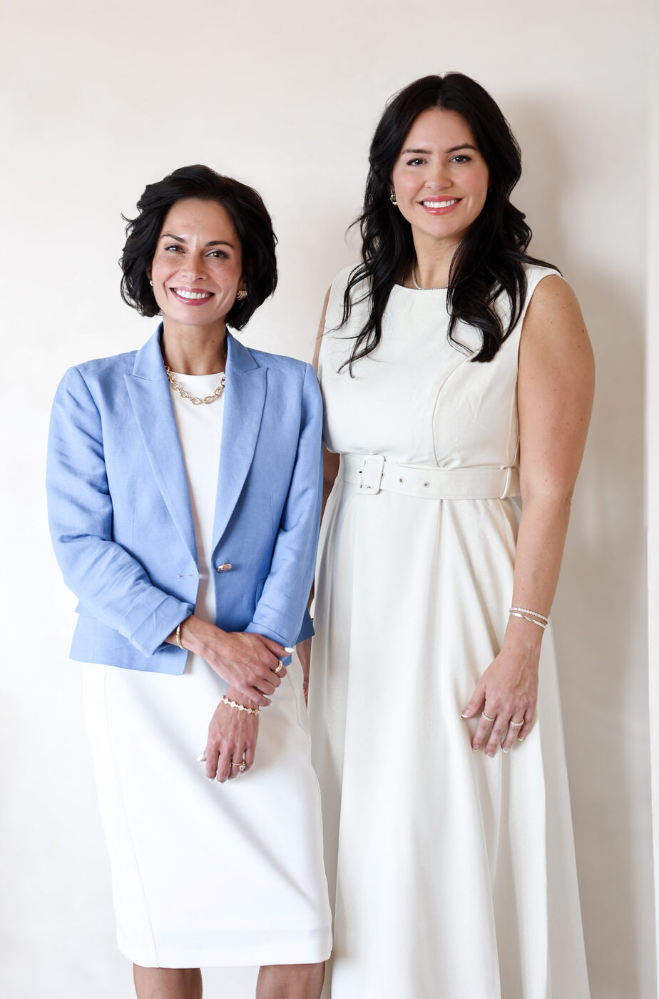 The two Catalina founders standing together, one in a pale blue blazer, one in a white dress